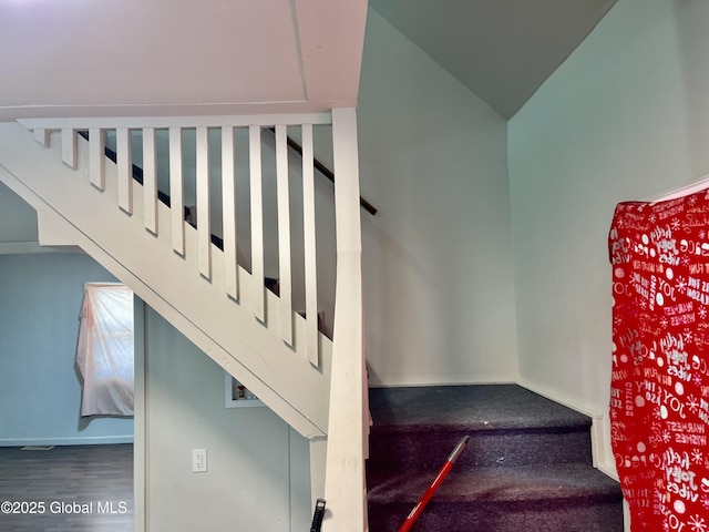 stairs featuring baseboards and wood finished floors