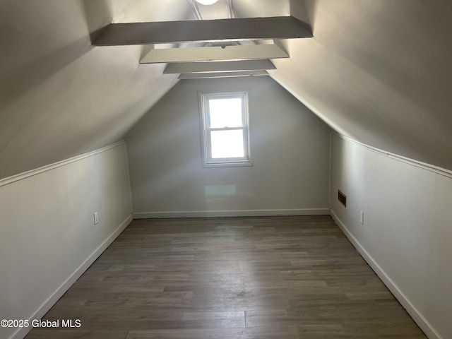 bonus room with lofted ceiling, visible vents, baseboards, and wood finished floors