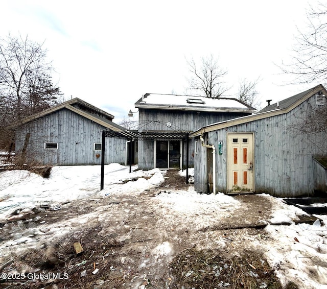 view of snow covered rear of property