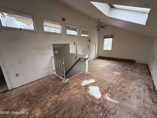 additional living space featuring a baseboard heating unit and vaulted ceiling with skylight