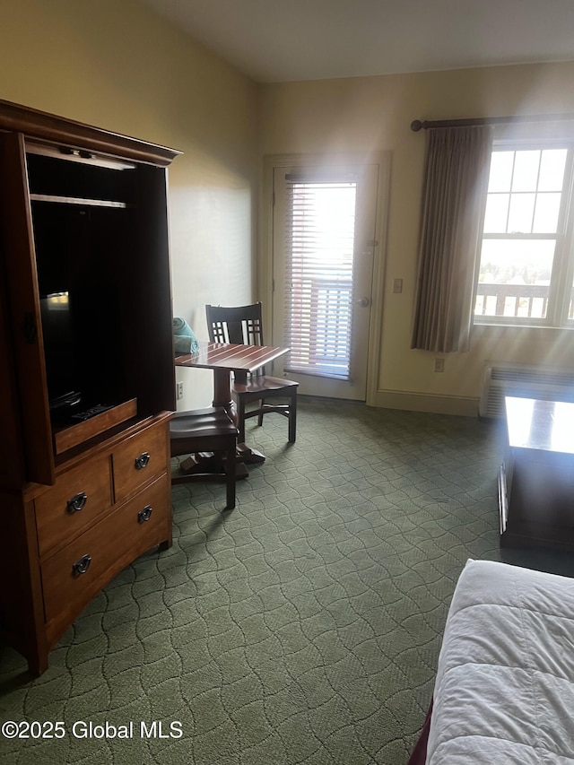 bedroom featuring dark colored carpet and baseboards