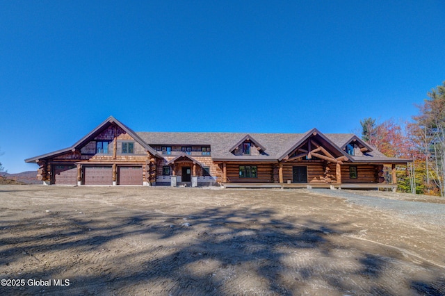 log home with covered porch and log siding