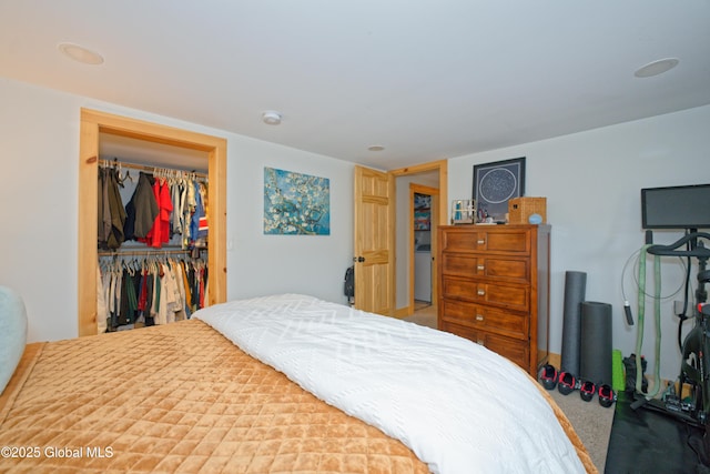 bedroom featuring a closet, a walk in closet, and washer / dryer