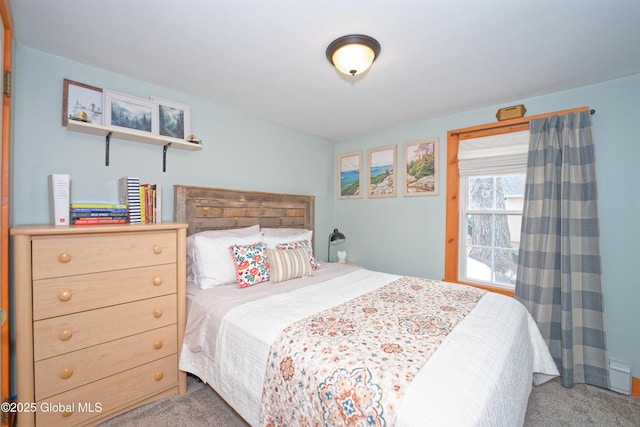 carpeted bedroom featuring a baseboard heating unit