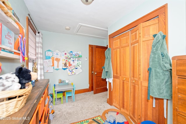 interior space with attic access, baseboards, and carpet flooring