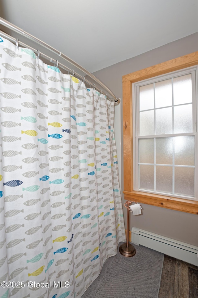 full bathroom featuring baseboard heating