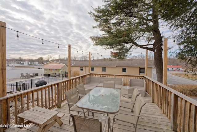 wooden deck featuring outdoor dining area and fence