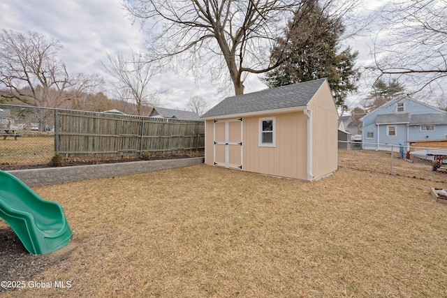 exterior space featuring a playground and a fenced backyard