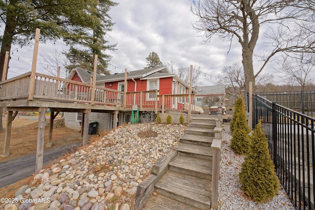 view of yard with a deck, a residential view, fence, and stairs