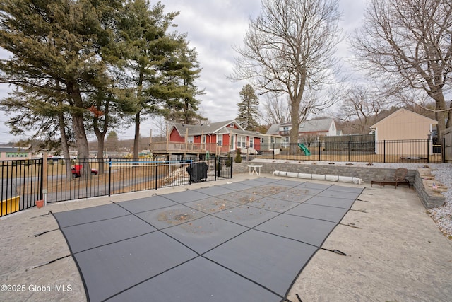 pool featuring a patio, fence, and a residential view