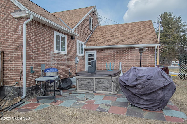 view of patio / terrace featuring area for grilling and a hot tub