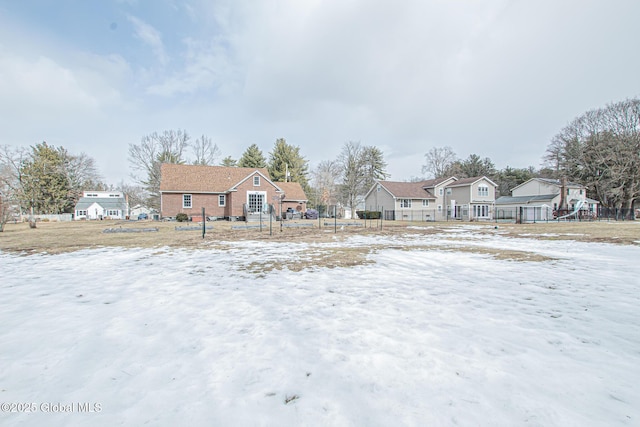 yard covered in snow with a residential view