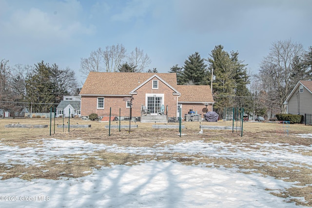 view of front of property with brick siding and fence