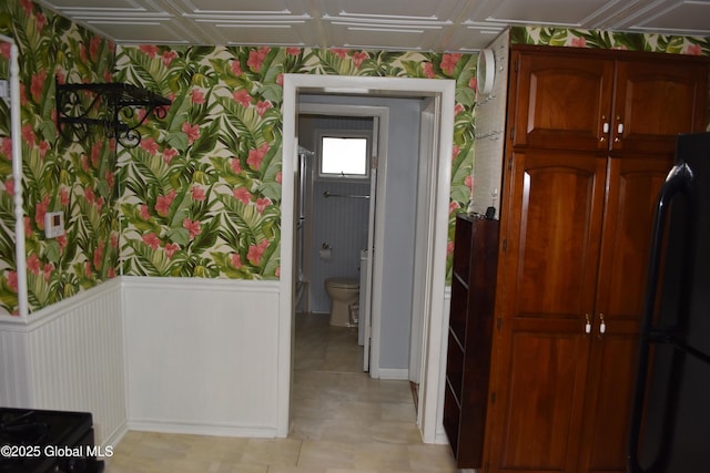 corridor featuring wallpapered walls and an ornate ceiling