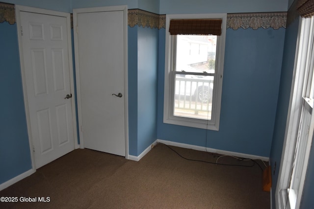 unfurnished bedroom featuring baseboards and carpet floors