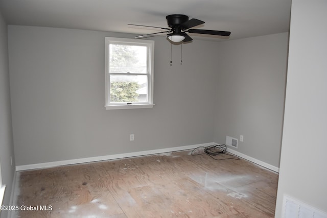 spare room featuring visible vents, baseboards, and ceiling fan