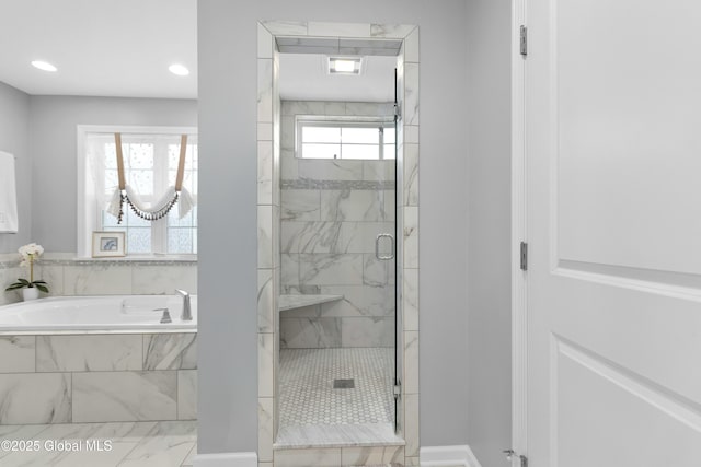 bathroom with recessed lighting, a bath, and a shower stall