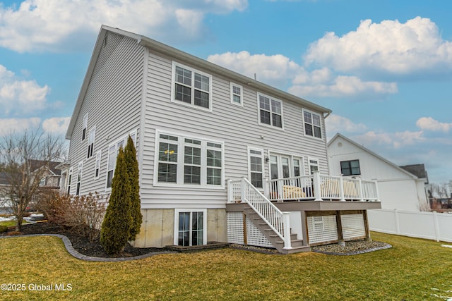 back of house featuring a yard, a deck, stairs, and fence