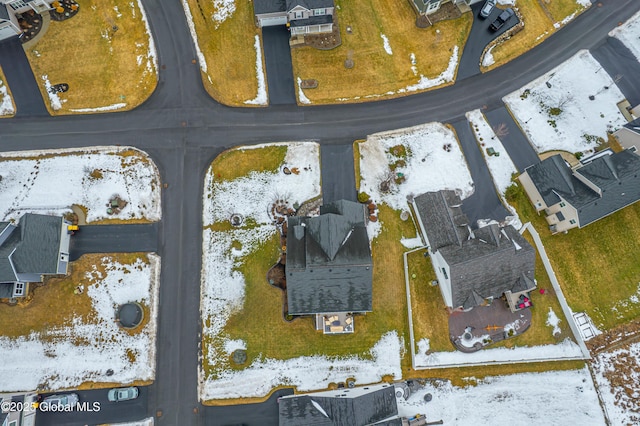 snowy aerial view featuring a residential view