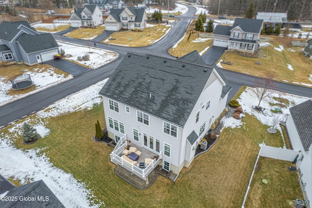 snowy aerial view featuring a residential view