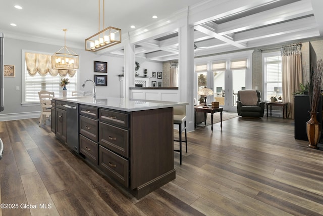 kitchen featuring a kitchen bar, dark wood-type flooring, a wealth of natural light, and coffered ceiling