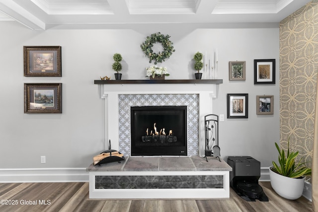 interior details with baseboards, wood finished floors, and a tiled fireplace