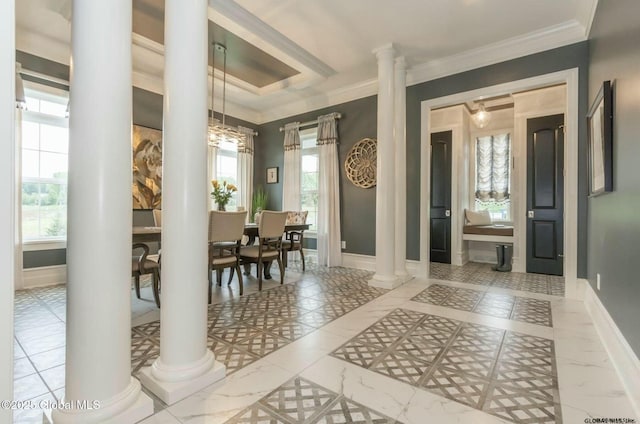 foyer entrance with a healthy amount of sunlight, baseboards, and decorative columns