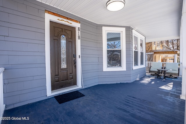 entrance to property featuring covered porch