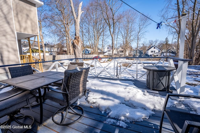 deck with outdoor dining area, fence, and a residential view