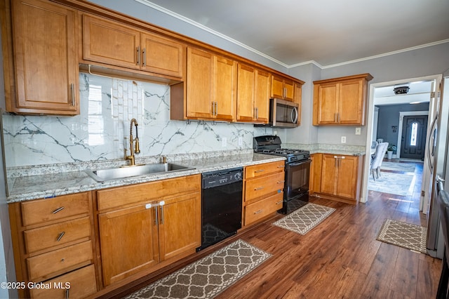 kitchen featuring dark wood-style flooring, a sink, brown cabinets, black appliances, and crown molding