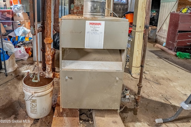 utility room featuring heating unit