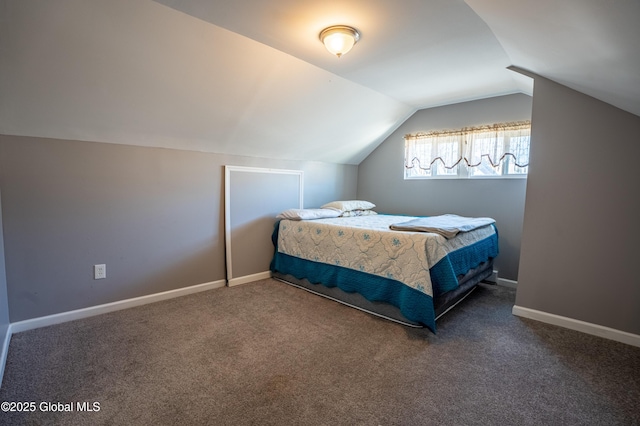 carpeted bedroom with lofted ceiling and baseboards