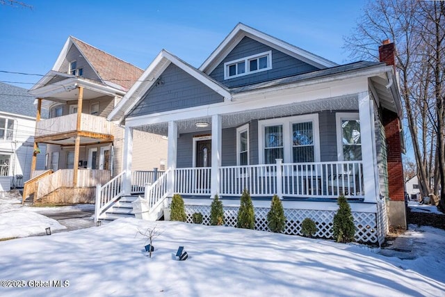 818 Bedford Rd, Schenectady, NY 12308 - view of front facade featuring covered porch and a chimney