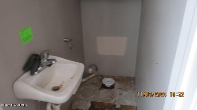 bathroom with water heater and a sink