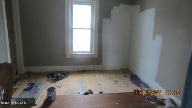 unfurnished room with baseboards