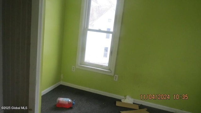 spare room with baseboards