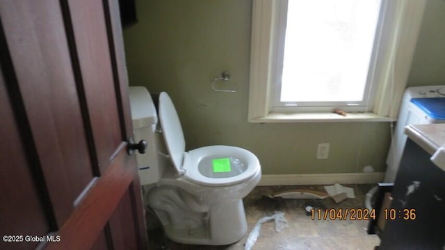 bathroom featuring toilet and baseboards