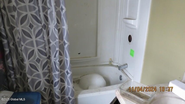 bathroom featuring vanity and shower / bath combination with curtain