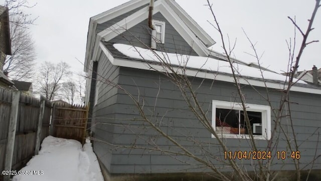 view of side of property featuring fence