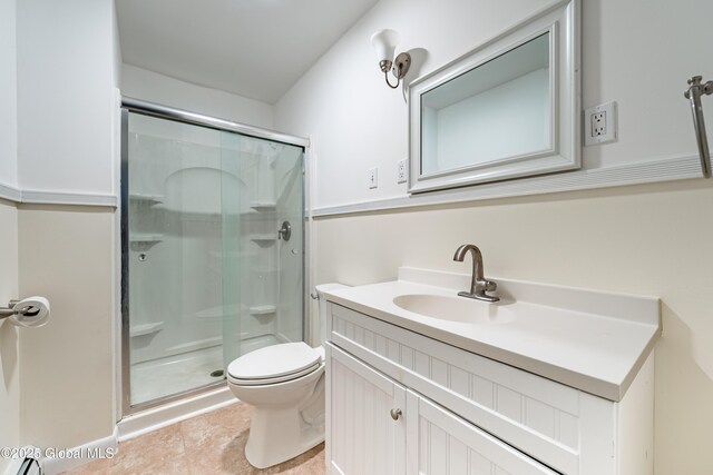 bathroom featuring a stall shower, tile patterned flooring, vanity, and toilet