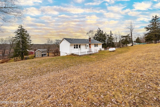 view of front of house featuring crawl space, a front lawn, and a chimney