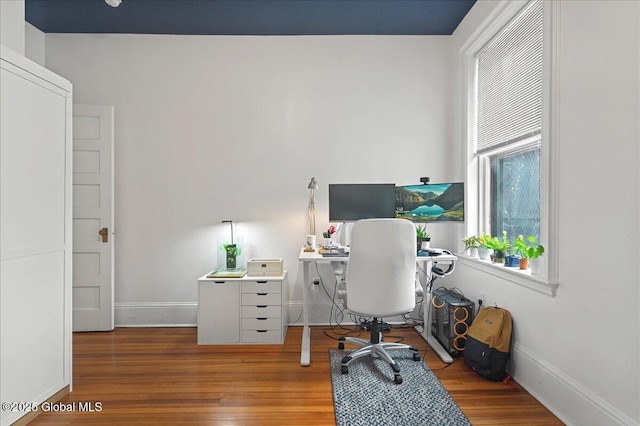 home office with wood finished floors and baseboards