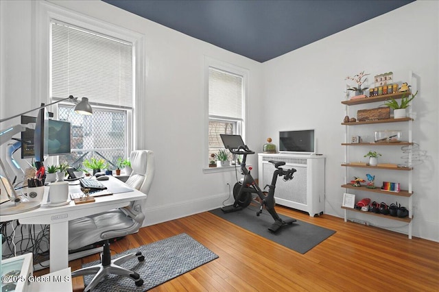 home office featuring wood finished floors and baseboards