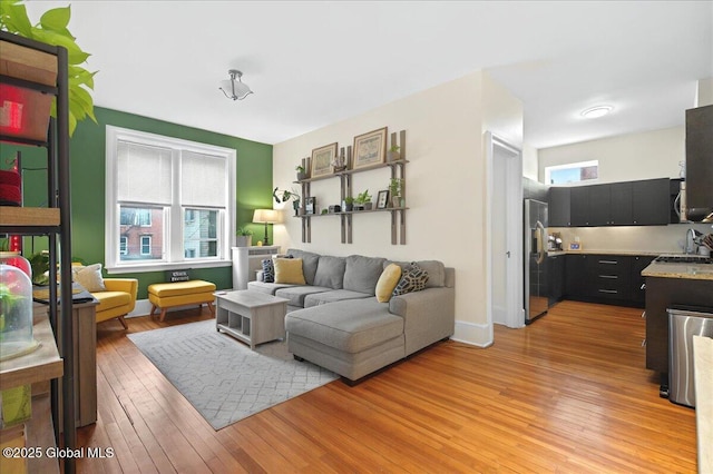 living area with light wood finished floors and plenty of natural light