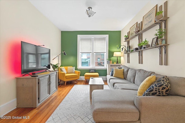 living area featuring light wood finished floors and baseboards