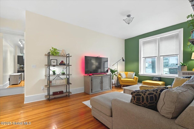 living area featuring light wood finished floors and baseboards