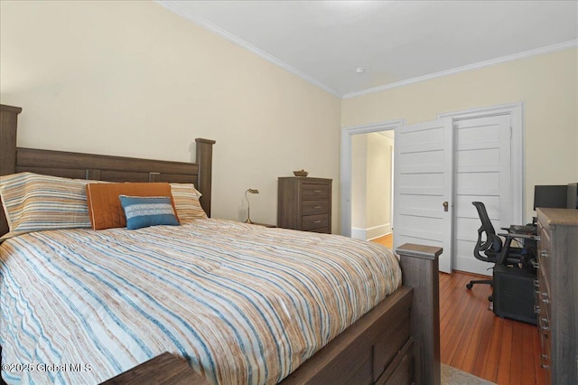 bedroom featuring ornamental molding and wood finished floors