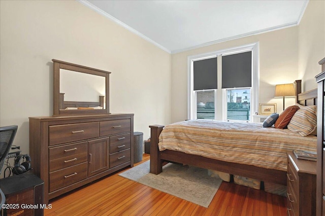 bedroom featuring light wood-style flooring and ornamental molding