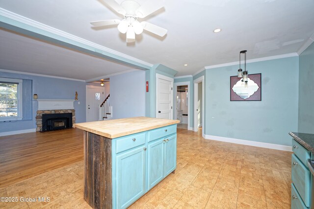 kitchen with butcher block counters, pendant lighting, baseboards, and ornamental molding