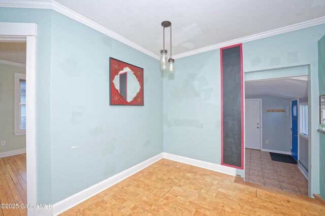 spare room featuring baseboards and ornamental molding